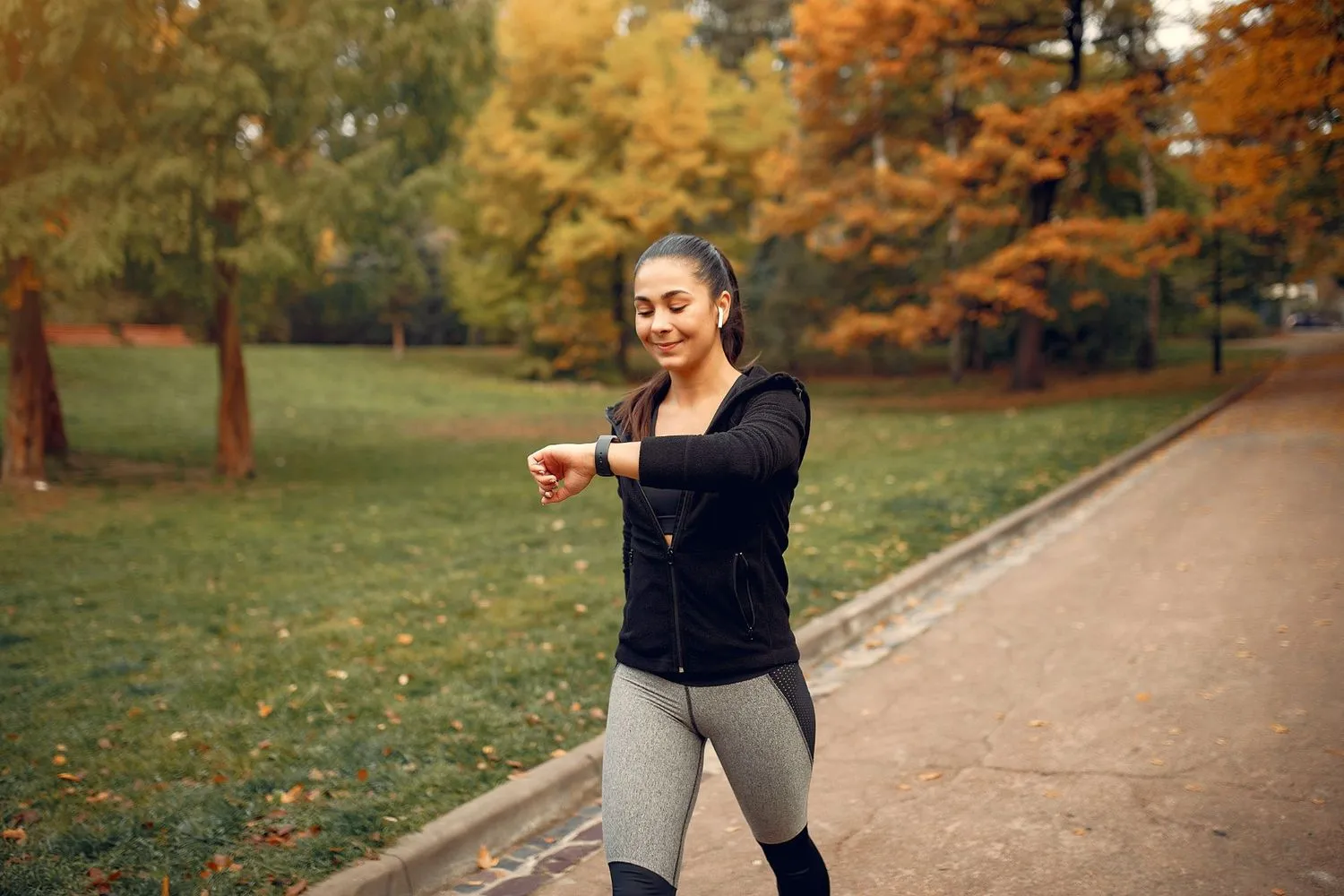 Woman walking in the park while tracking fitness progress exercise with Semaglutide for better weight loss results.