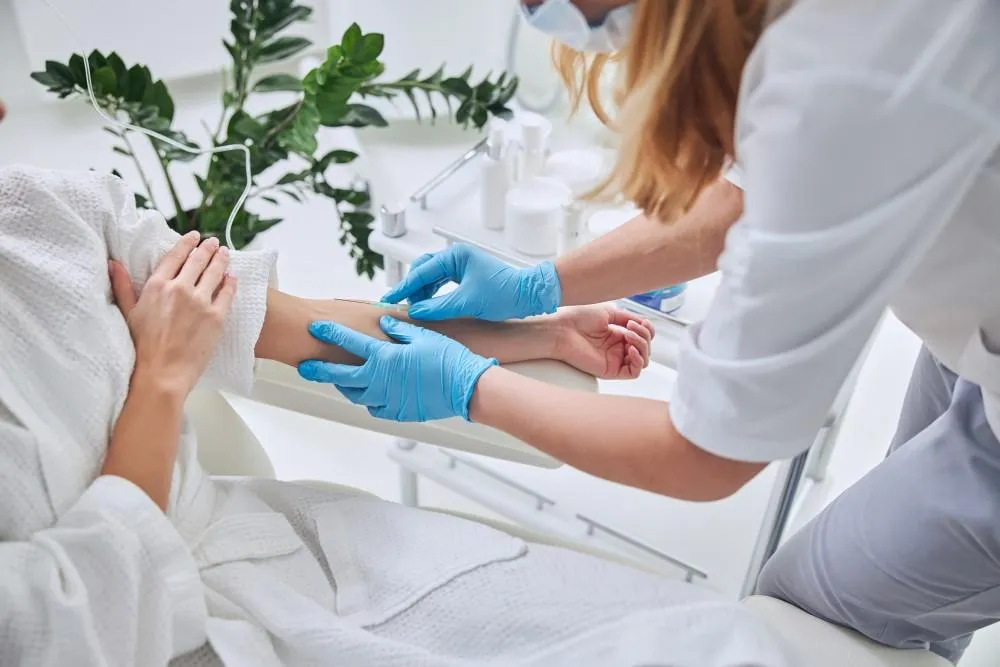  Medical professional administering IV drip therapy for hydration and wellness at Georgia Family Care clinic<br />
